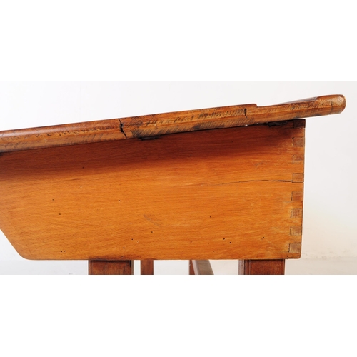 588 - A mid 20th century teak wood school writing draughtsmans desk. The desk raised on squared supports w... 