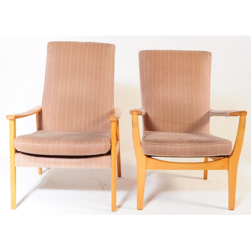 592 - Manner of Parker Knoll - a matching pair of Mid-century retro armchairs / lounge chairs raised on be... 