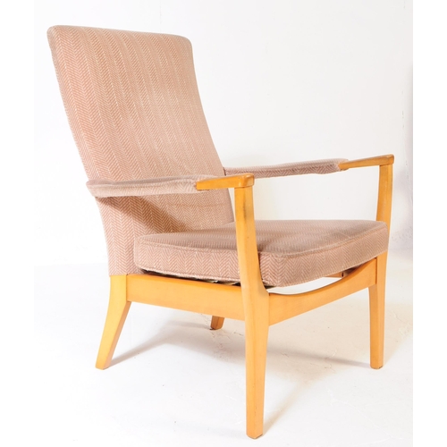 592 - Manner of Parker Knoll - a matching pair of Mid-century retro armchairs / lounge chairs raised on be... 