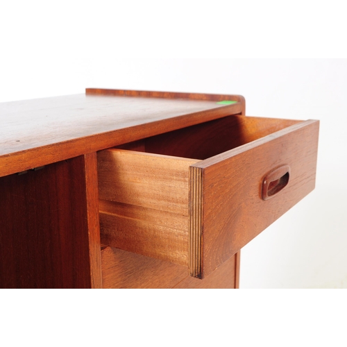 597 - A retro mid 20th Century teak sideboard credenza cabinet of small proportions.  Having cupboard stor... 