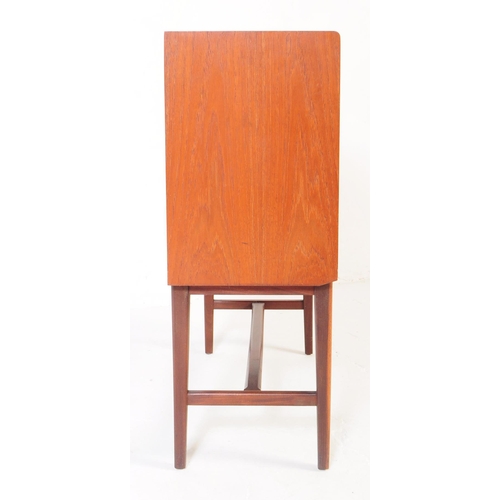 597 - A retro mid 20th Century teak sideboard credenza cabinet of small proportions.  Having cupboard stor... 