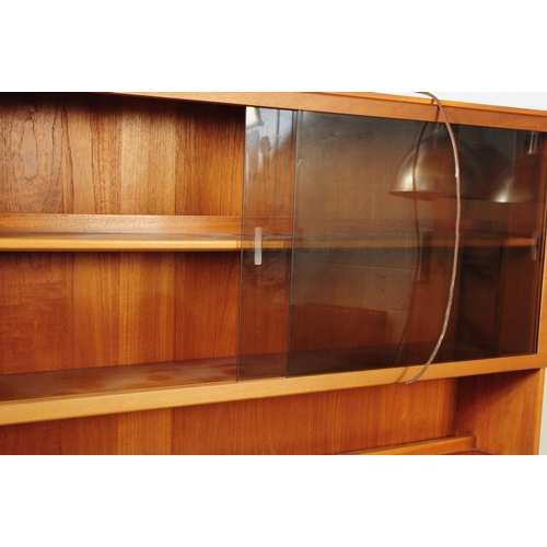 601 - A retro 20th century British designed teak upright high cabinet / display bookcase. Part open bookca... 