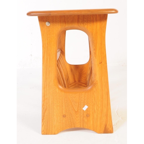 602 - ERCOL - A late 20th century Ercol beech wood magazine rack / table in the Chaucer range / pattern. R... 