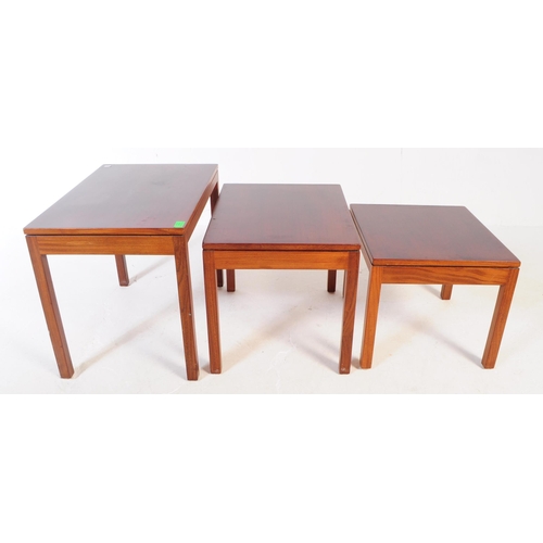 614 - A mid 20th century wood nest of tables. The nest of rectangular form with three stacking tables each... 