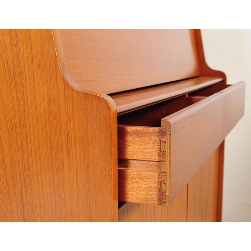 615 - Remploy - A mid 20th century teak wood bureau desk. Of rectangular form with pull down front cabinet... 