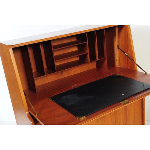 615 - Remploy - A mid 20th century teak wood bureau desk. Of rectangular form with pull down front cabinet... 