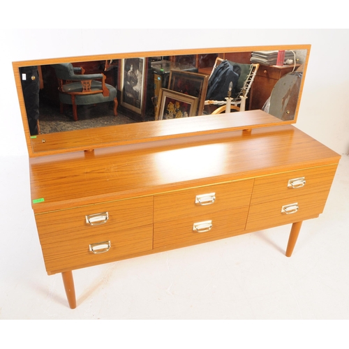 619 - A retro 20th Century melamine teak wood effect dressing table chest. Having a single mirror back abo... 