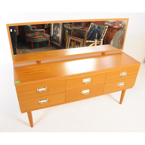 619 - A retro 20th Century melamine teak wood effect dressing table chest. Having a single mirror back abo... 