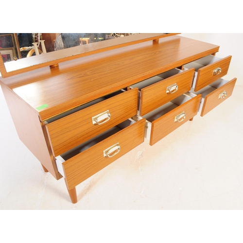 619 - A retro 20th Century melamine teak wood effect dressing table chest. Having a single mirror back abo... 