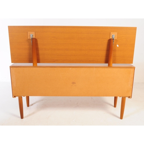 619 - A retro 20th Century melamine teak wood effect dressing table chest. Having a single mirror back abo... 