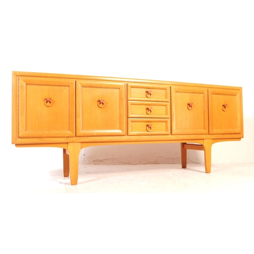 621 - Elliotts of Newbury - A mid 20th century EON teak wood sideboard credenza. The sideboard having a se... 