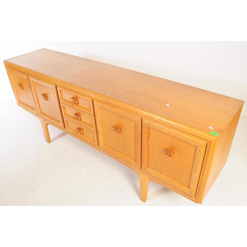 621 - Elliotts of Newbury - A mid 20th century EON teak wood sideboard credenza. The sideboard having a se... 