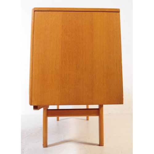 621 - Elliotts of Newbury - A mid 20th century EON teak wood sideboard credenza. The sideboard having a se... 