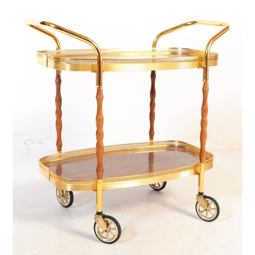 622 - A mid 20th century circa 1970s gilt frame cocktail / drinks trolley. The trolley having two tiers wi... 