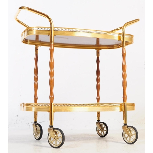 622 - A mid 20th century circa 1970s gilt frame cocktail / drinks trolley. The trolley having two tiers wi... 