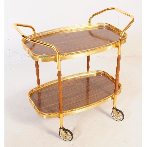 622 - A mid 20th century circa 1970s gilt frame cocktail / drinks trolley. The trolley having two tiers wi... 