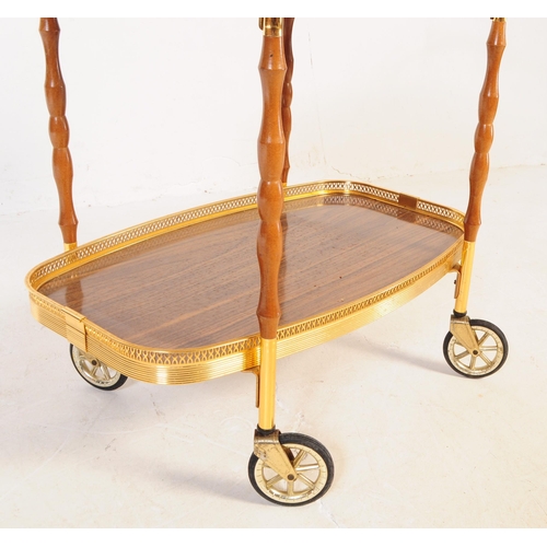 622 - A mid 20th century circa 1970s gilt frame cocktail / drinks trolley. The trolley having two tiers wi... 