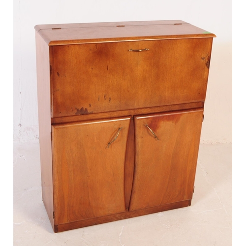 623 - A vintage mid 20th century walnut veneer cocktail cabinet. Raised on a plinth base with two shaped c... 