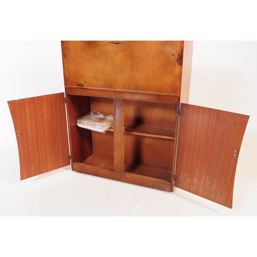 623 - A vintage mid 20th century walnut veneer cocktail cabinet. Raised on a plinth base with two shaped c... 