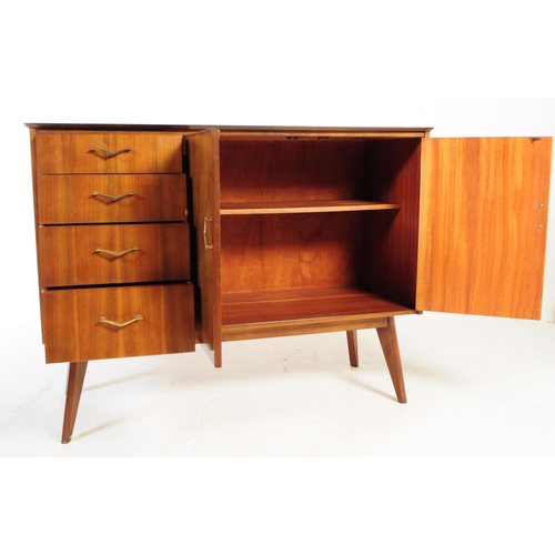 624 - A mid 20th century walnut veneer sideboard credenza. The sideboard raised on tapered wooden legs, wi... 