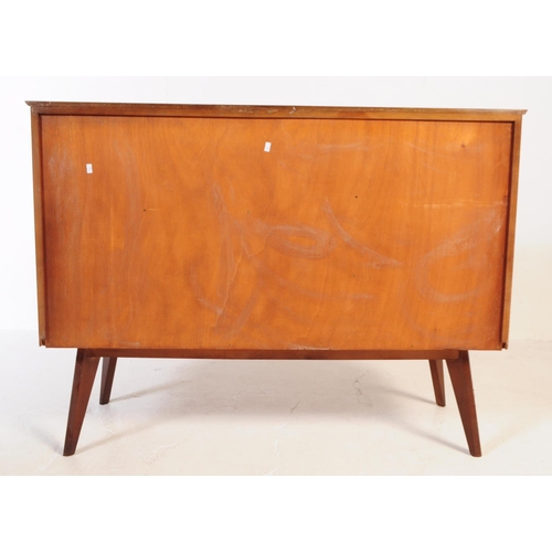 624 - A mid 20th century walnut veneer sideboard credenza. The sideboard raised on tapered wooden legs, wi... 