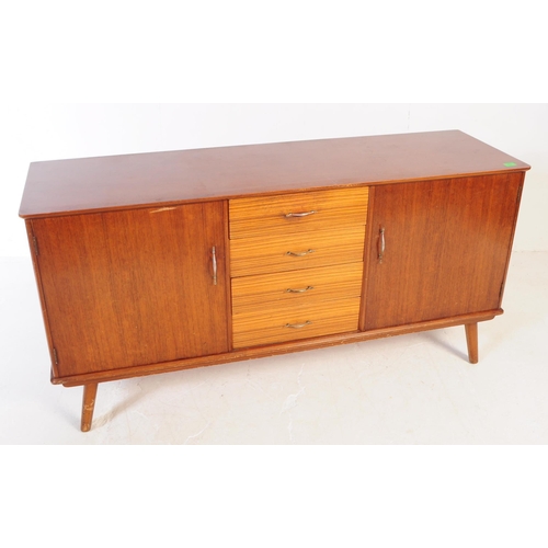 630 - A vintage mid 20th century teak veneer sideboard credenza. The sideboard having two cupboard doors f... 