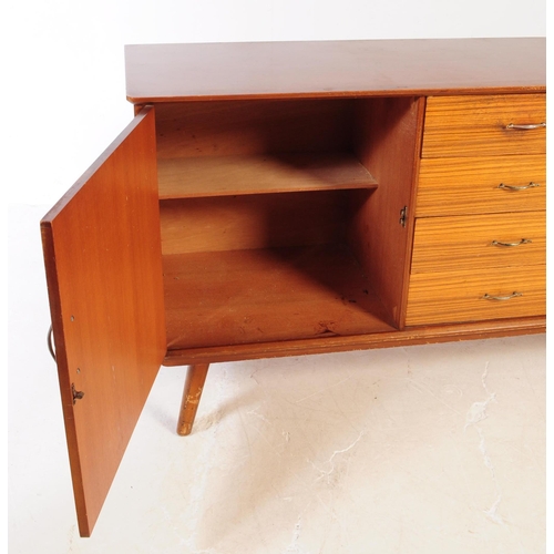 630 - A vintage mid 20th century teak veneer sideboard credenza. The sideboard having two cupboard doors f... 