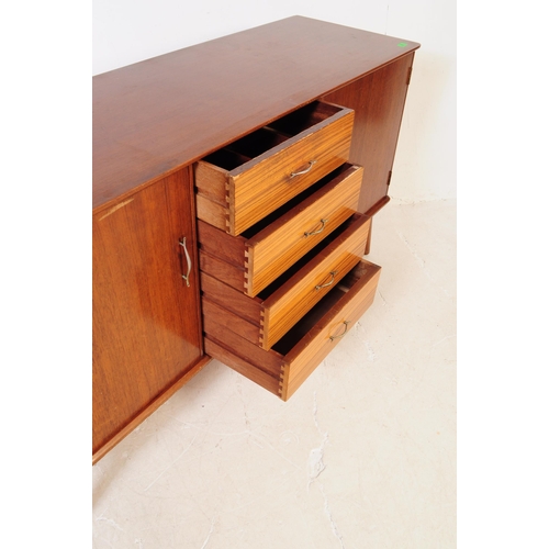 630 - A vintage mid 20th century teak veneer sideboard credenza. The sideboard having two cupboard doors f... 