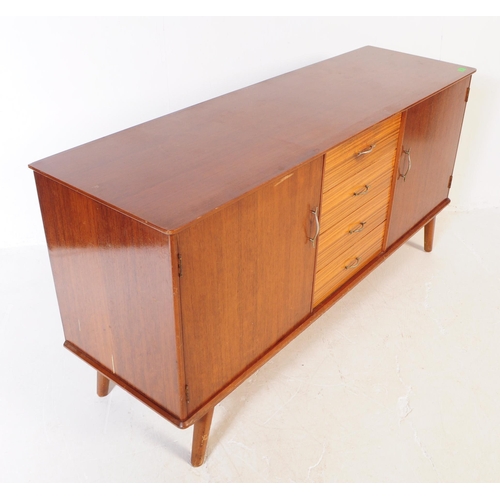 630 - A vintage mid 20th century teak veneer sideboard credenza. The sideboard having two cupboard doors f... 