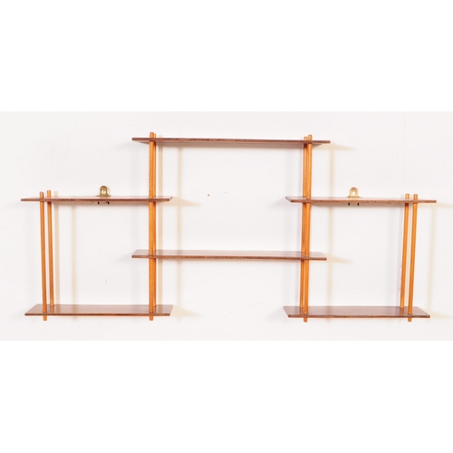 633 - A pair of mid 20th century wall mounted wotnot etagere shelves / bookcases. Each of the bookcases fe... 