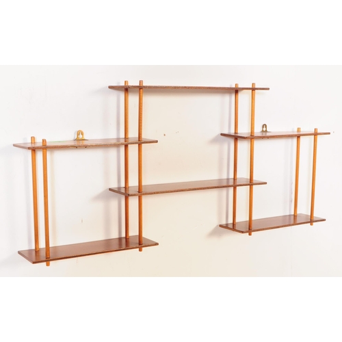 633 - A pair of mid 20th century wall mounted wotnot etagere shelves / bookcases. Each of the bookcases fe... 