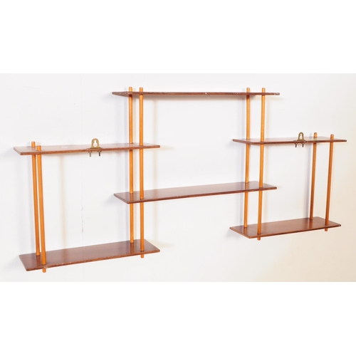 633 - A pair of mid 20th century wall mounted wotnot etagere shelves / bookcases. Each of the bookcases fe... 