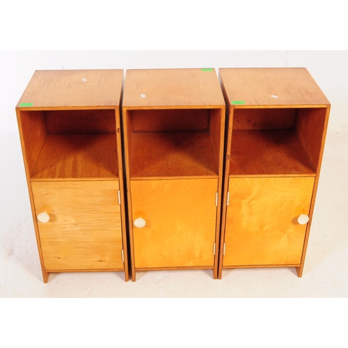 634 - A collection of three mid 20th century plywood bedside table / cupboards. The bedsides each featurin... 