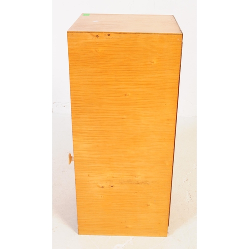 634 - A collection of three mid 20th century plywood bedside table / cupboards. The bedsides each featurin... 