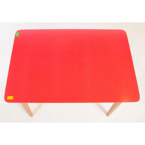 638 - A mid 20th century formica topped kitchen dining table and two stools. The table of rectangular form... 