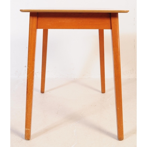 638 - A mid 20th century formica topped kitchen dining table and two stools. The table of rectangular form... 