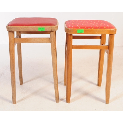 638 - A mid 20th century formica topped kitchen dining table and two stools. The table of rectangular form... 