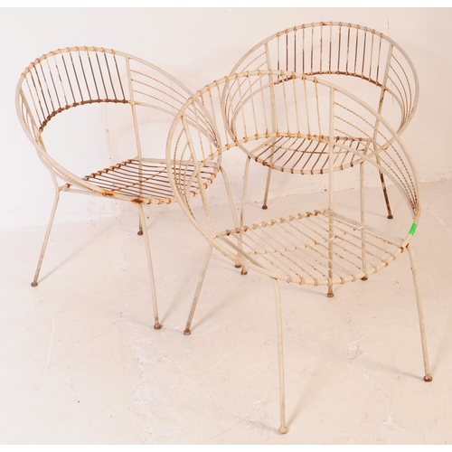 647 - A group of three vintage 20th century wire work satellite / egg chairs. Of round form with elbow res... 