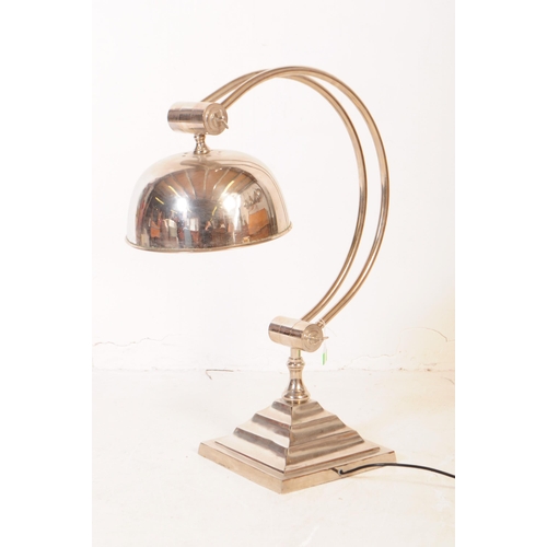 648 - Andrew Martin - A mid 20th century Andrew Martin industrial chromed metal table lamp. The lamp sat o... 