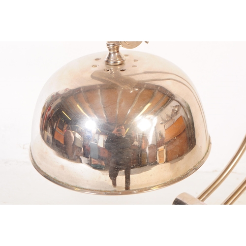 648 - Andrew Martin - A mid 20th century Andrew Martin industrial chromed metal table lamp. The lamp sat o... 