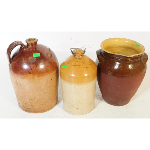 649 - Three early 20th century stoneware flagons / vase. All three in various earth tones, treacle glazes ... 