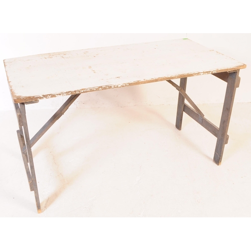 654 - A mid 20th century garden dining folding trestle table and chairs. The table painted in a white colo... 