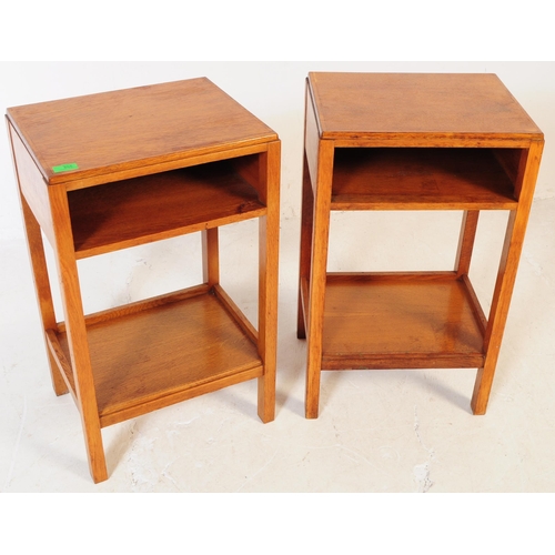 655 - A pair of mid 20th century Air Ministry manner oak bedside tables. The bedsides raised on four squar... 