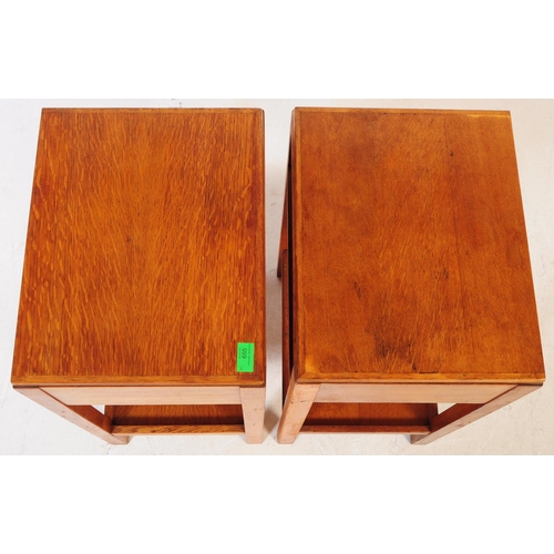 655 - A pair of mid 20th century Air Ministry manner oak bedside tables. The bedsides raised on four squar... 