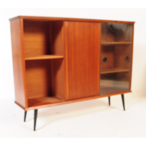 657 - A mid 20th century teak glazed bookcase. Having two sliding glass doors to front beside a teak slidi... 