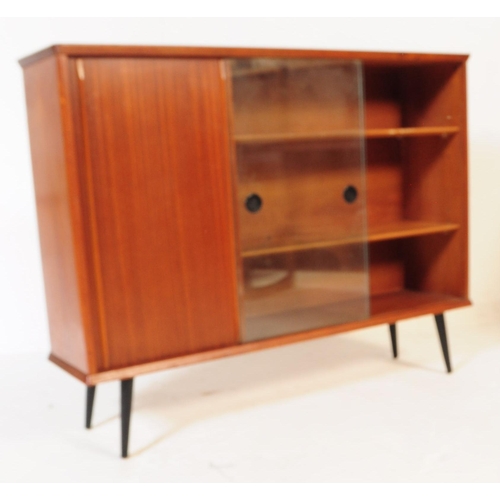 657 - A mid 20th century teak glazed bookcase. Having two sliding glass doors to front beside a teak slidi... 