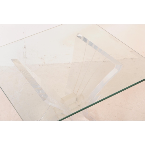 658 - A mid 20th century lucite and glass butterfly coffee table. The table having a square glass top with... 