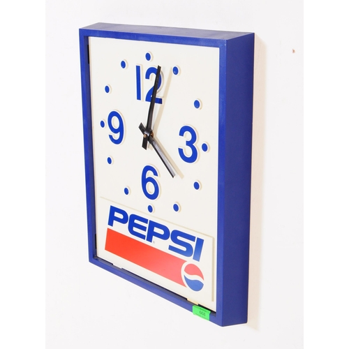 668 - Pepsi - A mid 20th century Pepsi branded plastic wall clock. The clock of rectangular form with blue... 