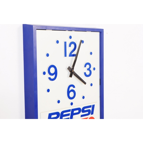 668 - Pepsi - A mid 20th century Pepsi branded plastic wall clock. The clock of rectangular form with blue... 