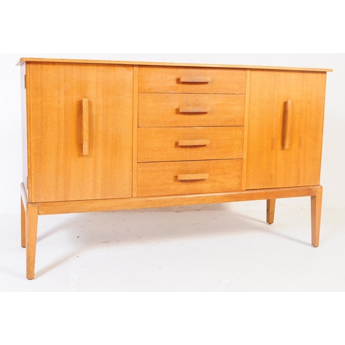 674 - British Modern Design - A vintage 20th century oak sideboard credenza. Of rectangular form with flar... 